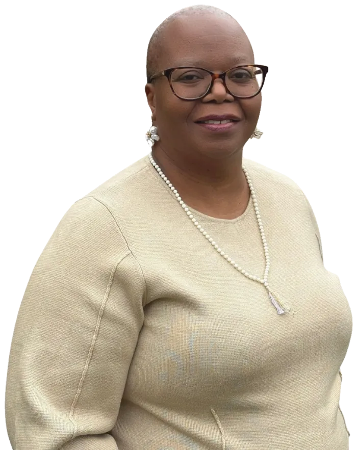 Martina Nyamainashe smiling, wearing a cream jumper and pearl necklace